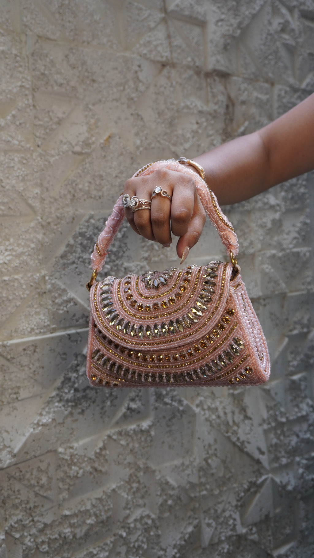 Pink bridal clutch reverse with vertical rows of pearl-like beads