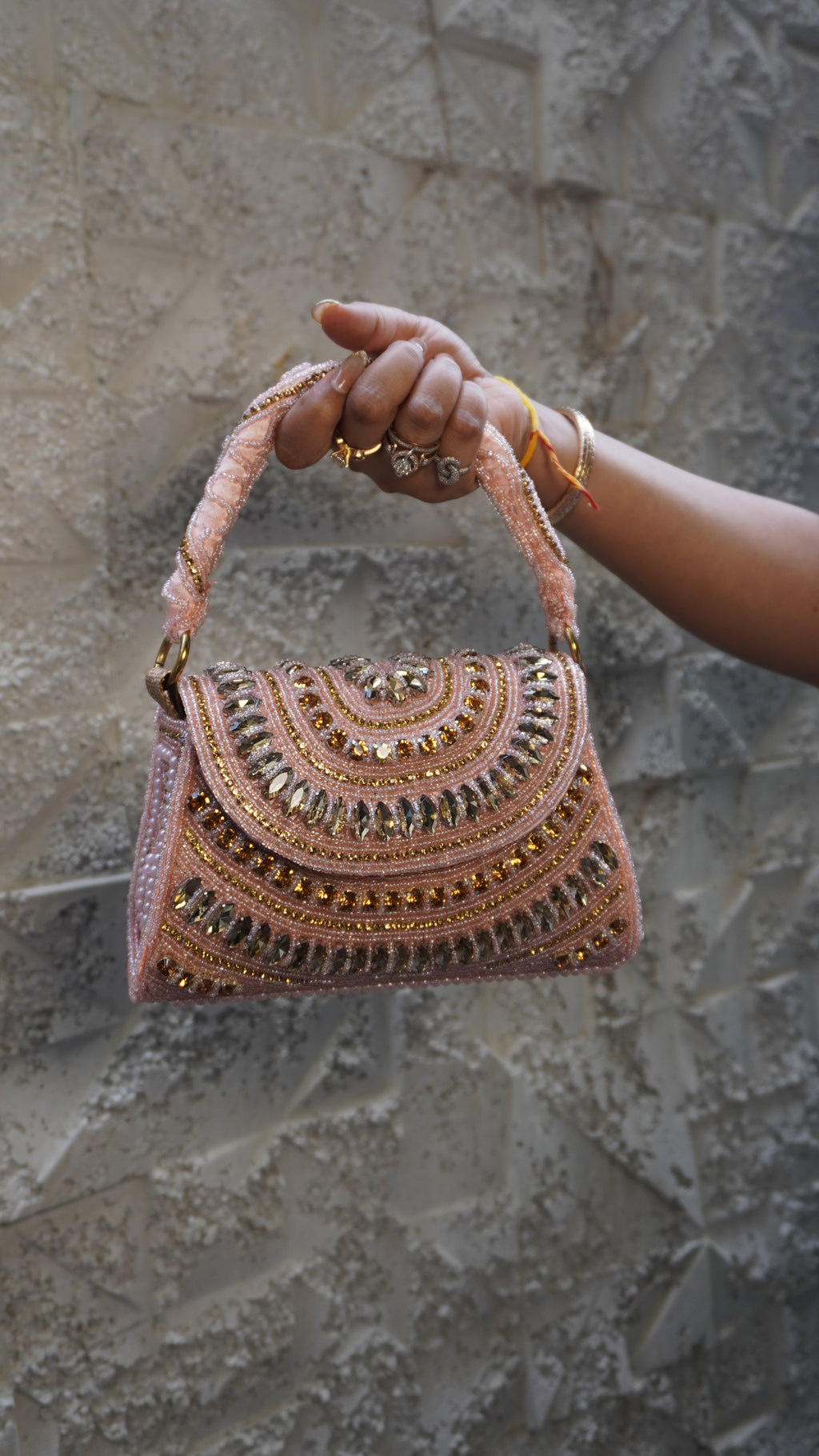 Pink embroidered bridal clutch front with embellished handle