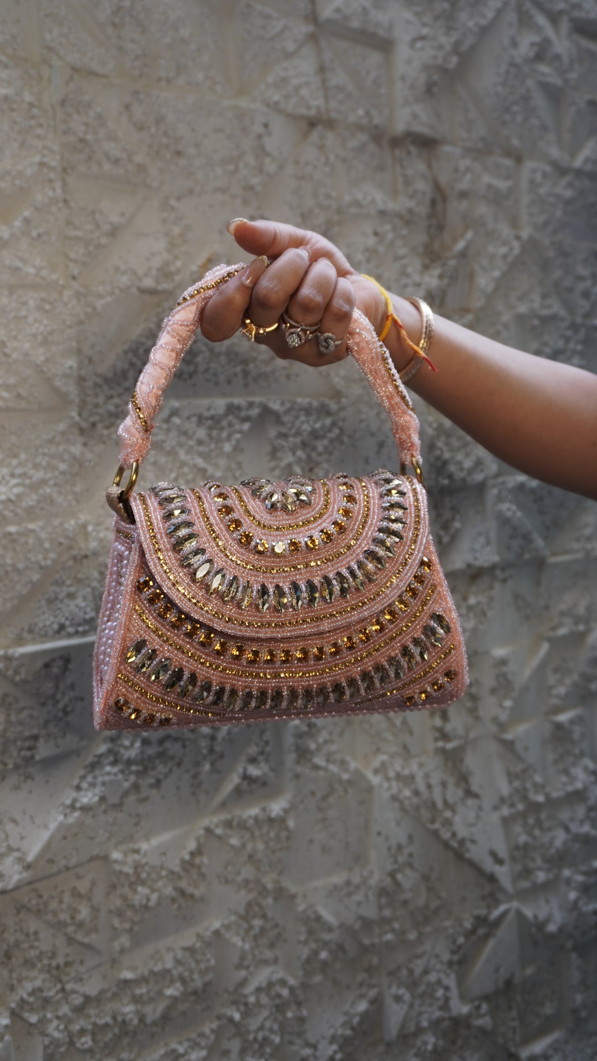 Pink embroidered bridal clutch front with embellished handle