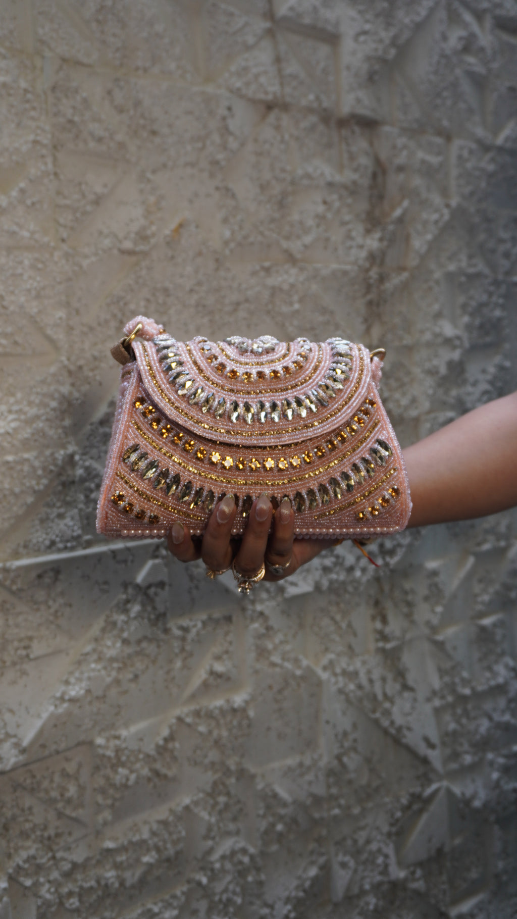 Pink bridal clutch close-up of U-shaped embroidery and beadwork