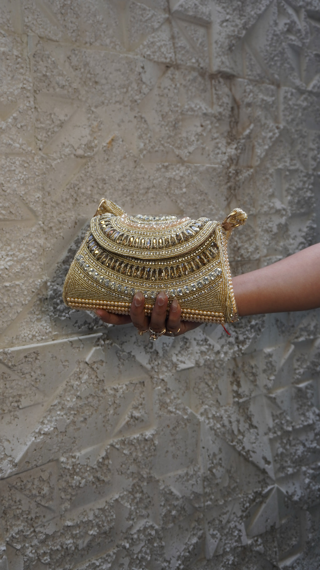 Golden bridal clutch with layered U-shaped beadwork and matching handle