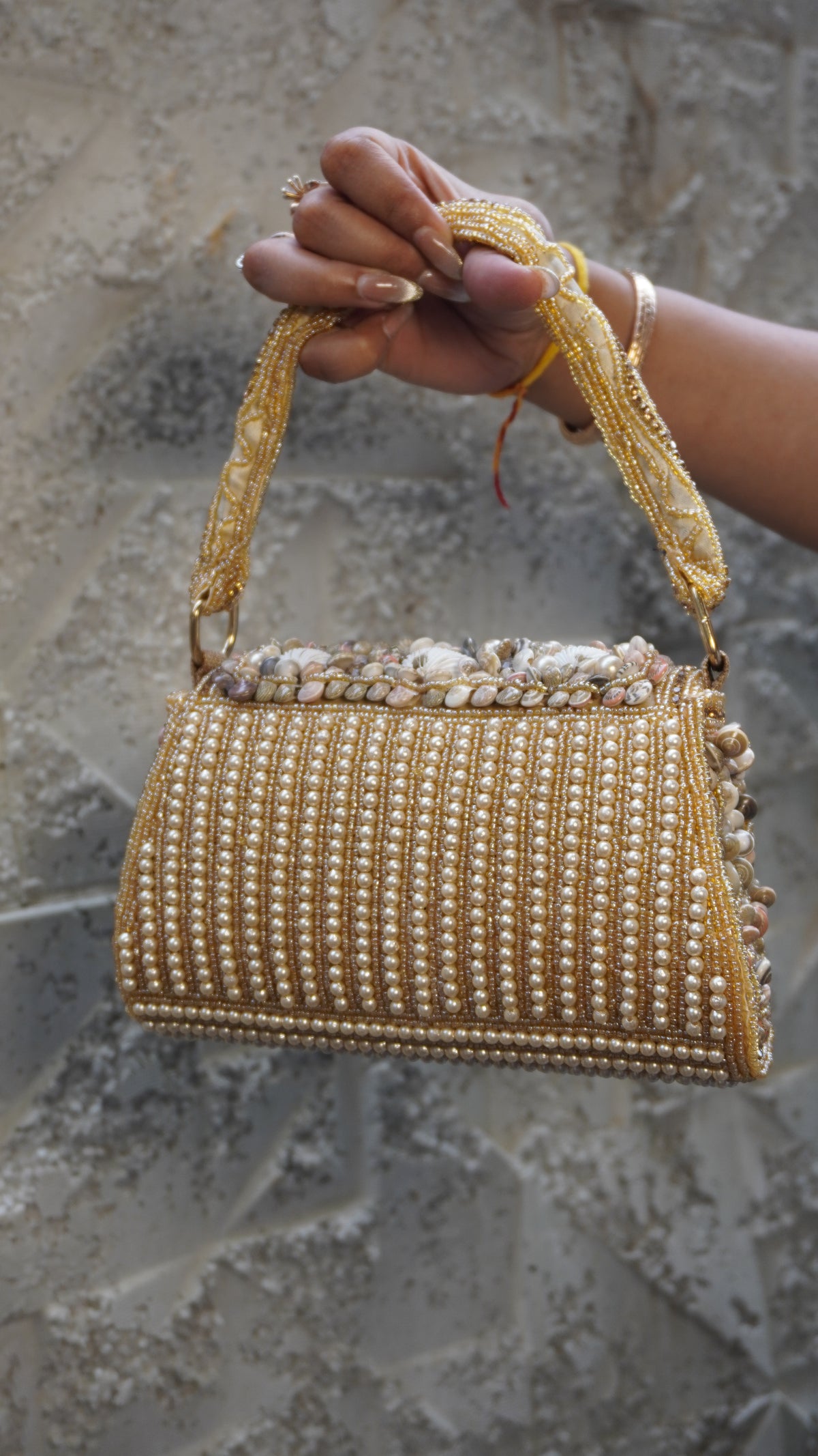 Golden shell work clutch reverse with vertical pearl-like beadwork