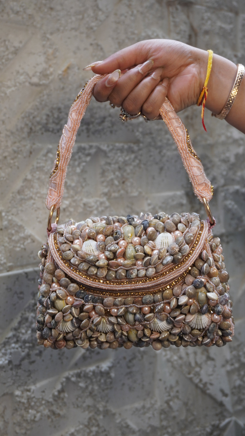 Pink shell work clutch front with curved embellished flap