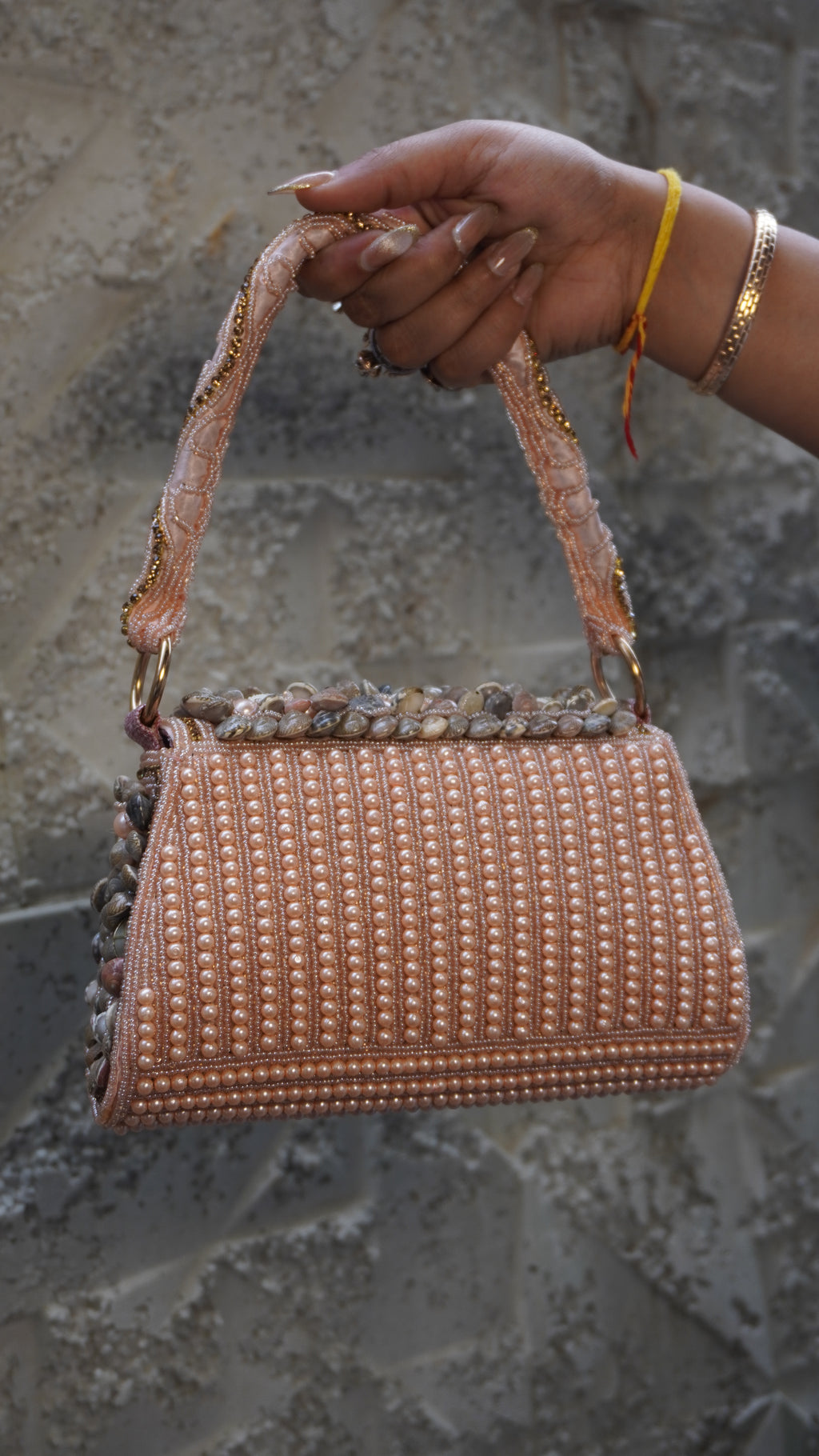 Pink shell work clutch reverse with vertical pearl-like beadwork
