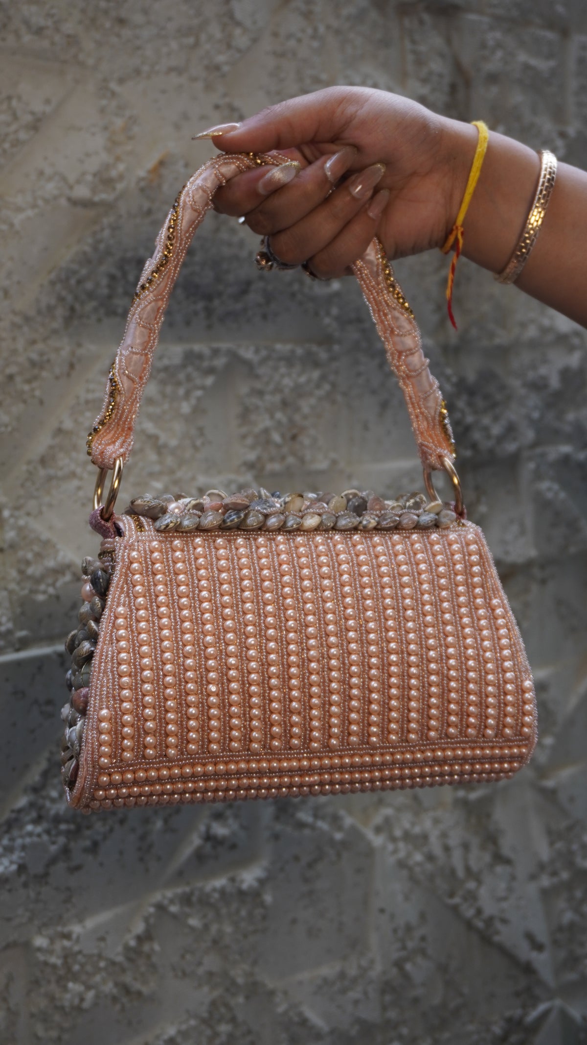 Pink shell work clutch reverse with vertical pearl-like beadwork