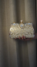 Brass clutch golden-toned reverse with engraved rose pattern
