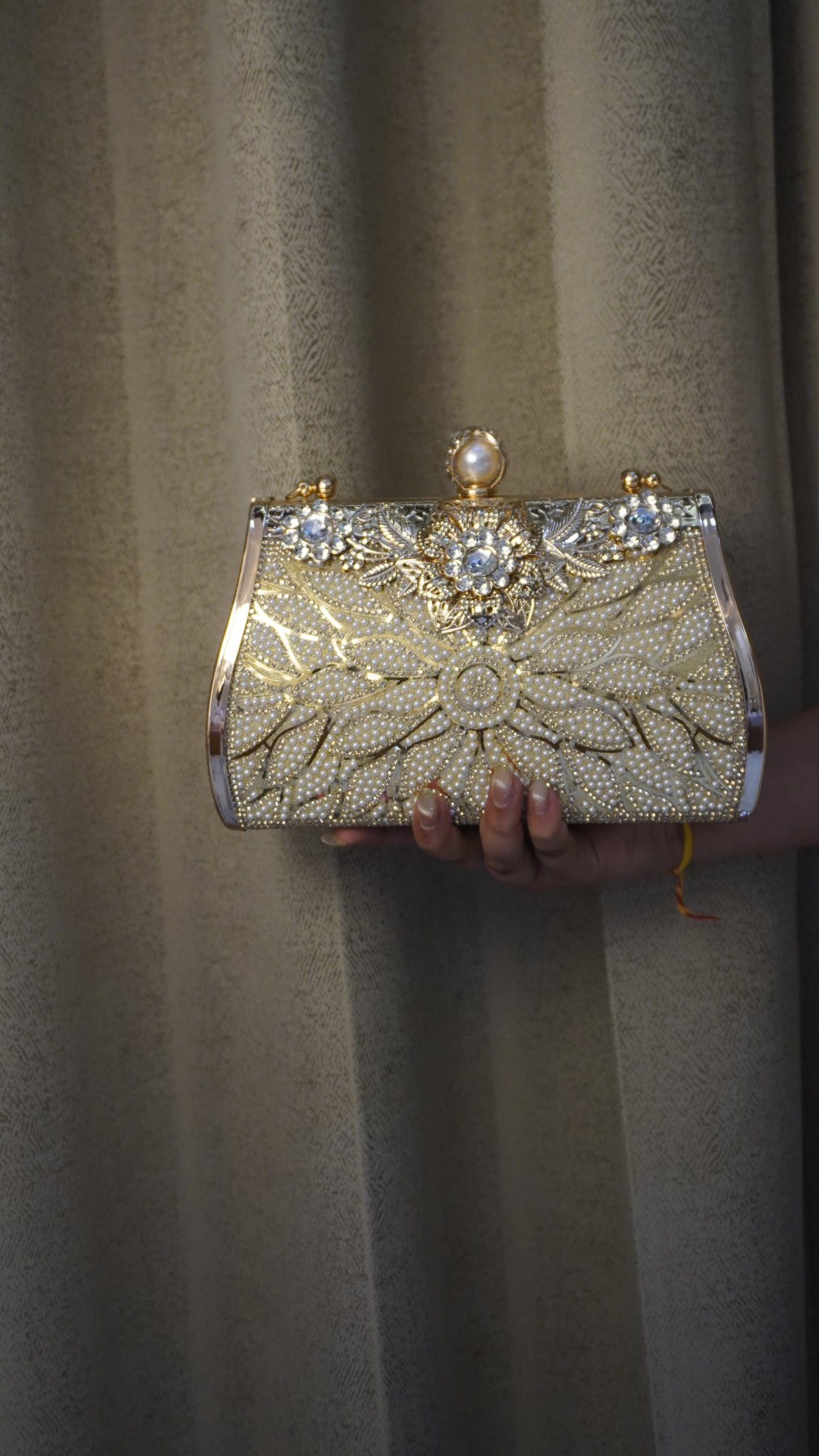Brass clutch golden-toned reverse with engraved rose pattern