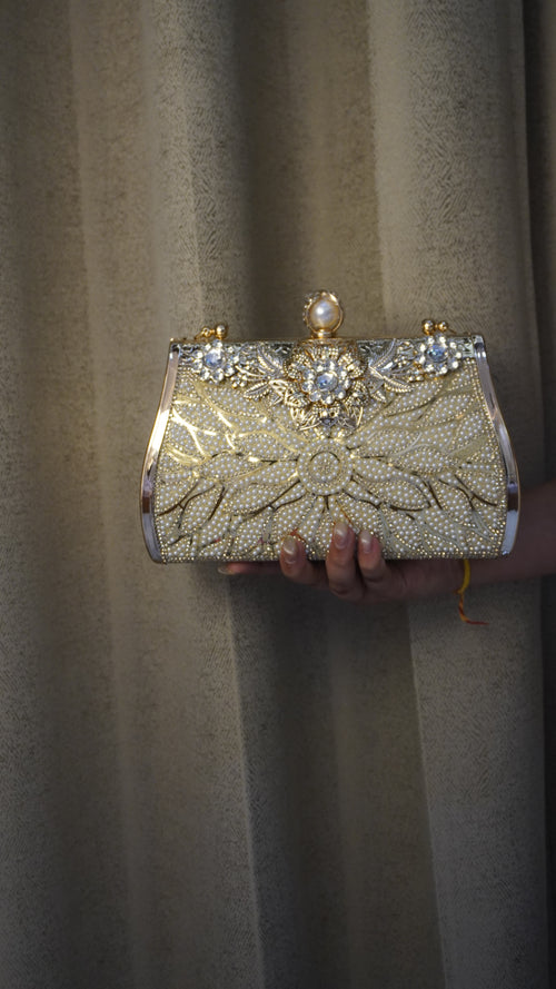 Brass clutch golden-toned reverse with engraved rose pattern