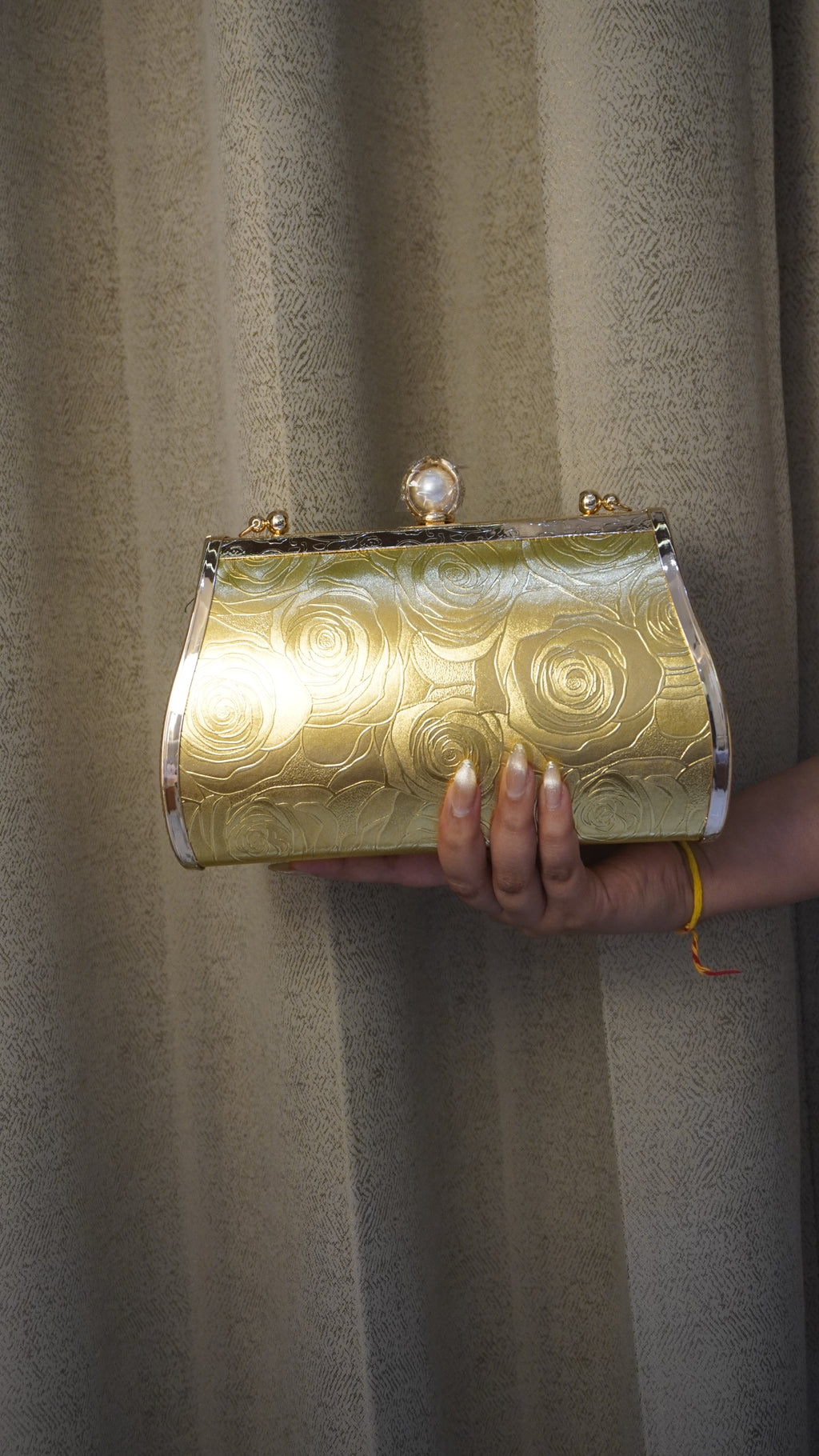 Brass clutch golden-toned reverse with engraved rose pattern