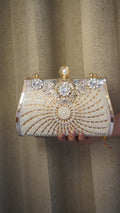 Brass clutch with radiating pearl beadwork and geometric decorative accents