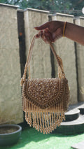 Rose-gold beaded clutch with embroidered handle, reverse view