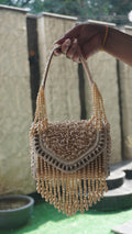 White-gold coloured handworked beaded clutch with embroidered handle, reverse view