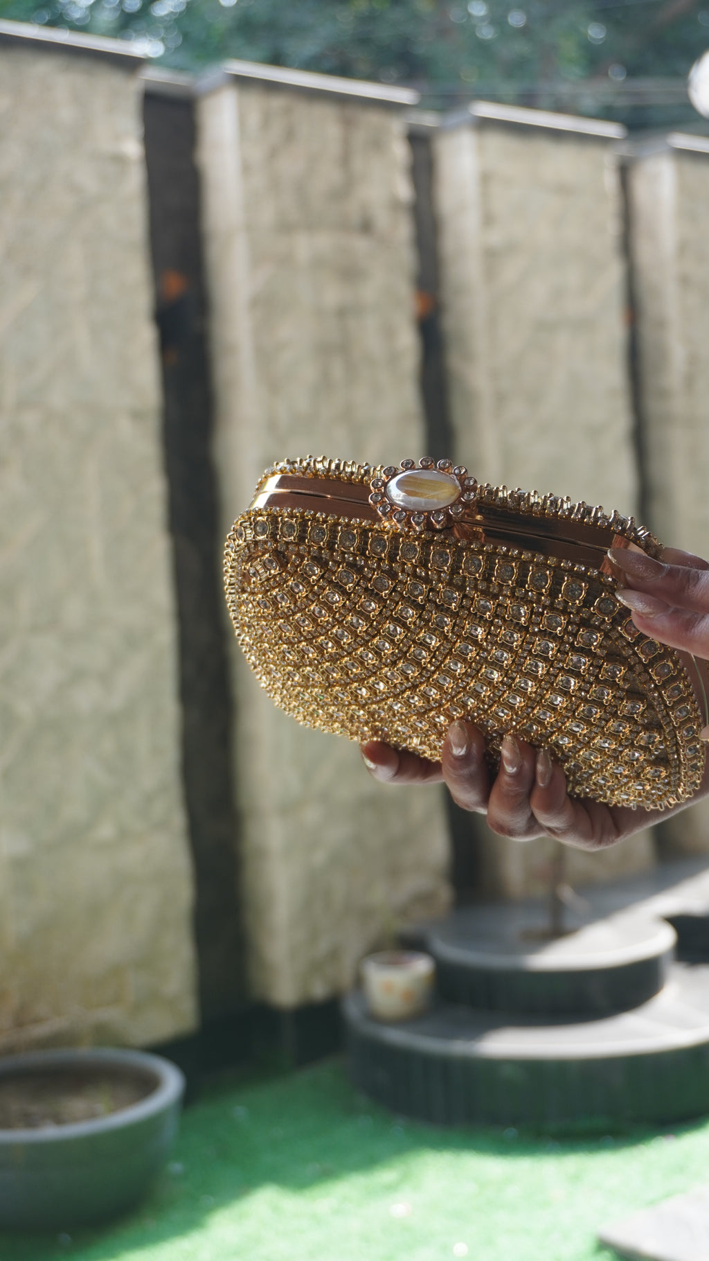 Golden Indian crystal bridal clutch shown with chain carry handle