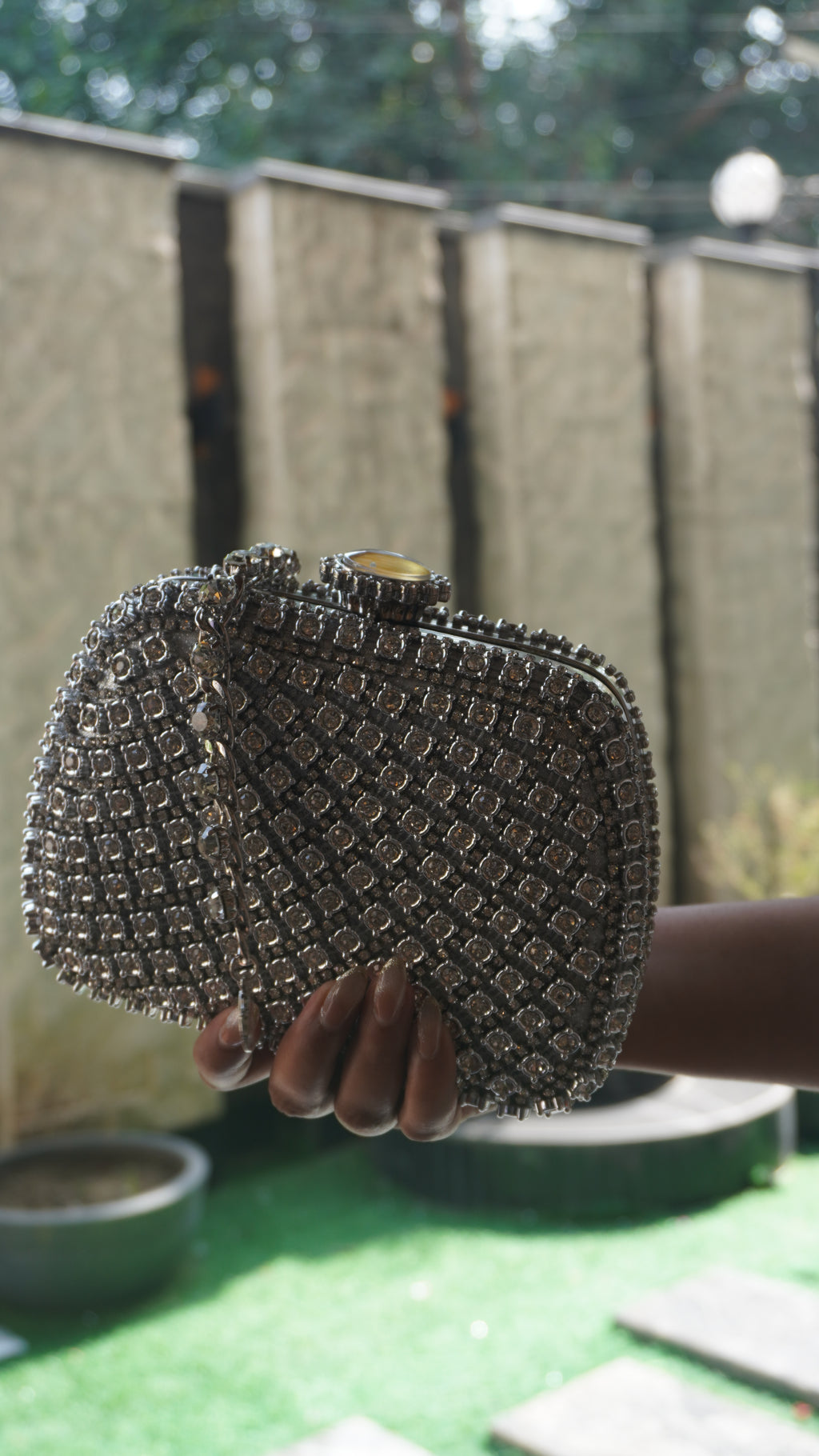 Angled view of silver Indian crystal bridal clutch