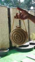 Golden circle bridal clutch with concentric Indian crystal work and chain handle