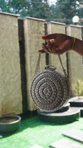 Silver circle bridal clutch with concentric Indian crystal work and chain handle