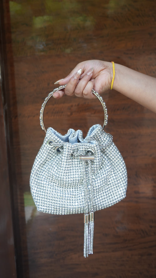 Silver potli with small beadwork all over, circular handle and hanging tassels