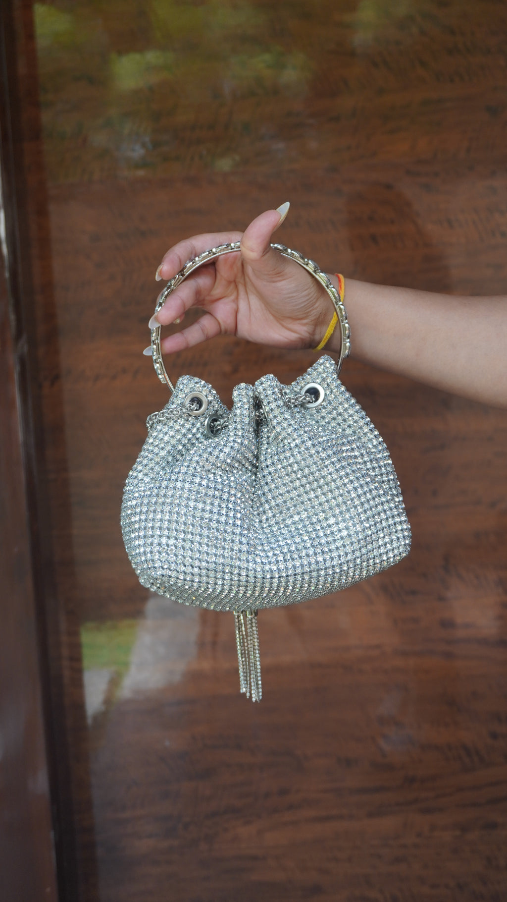 Silver beaded potli showing gathered opening and circular carry handle