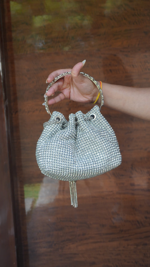 Silver beaded potli showing gathered opening and circular carry handle