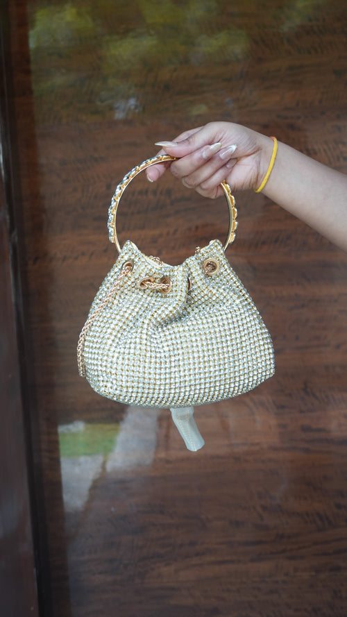 Golden beaded potli showing circular carry handle and gathered opening