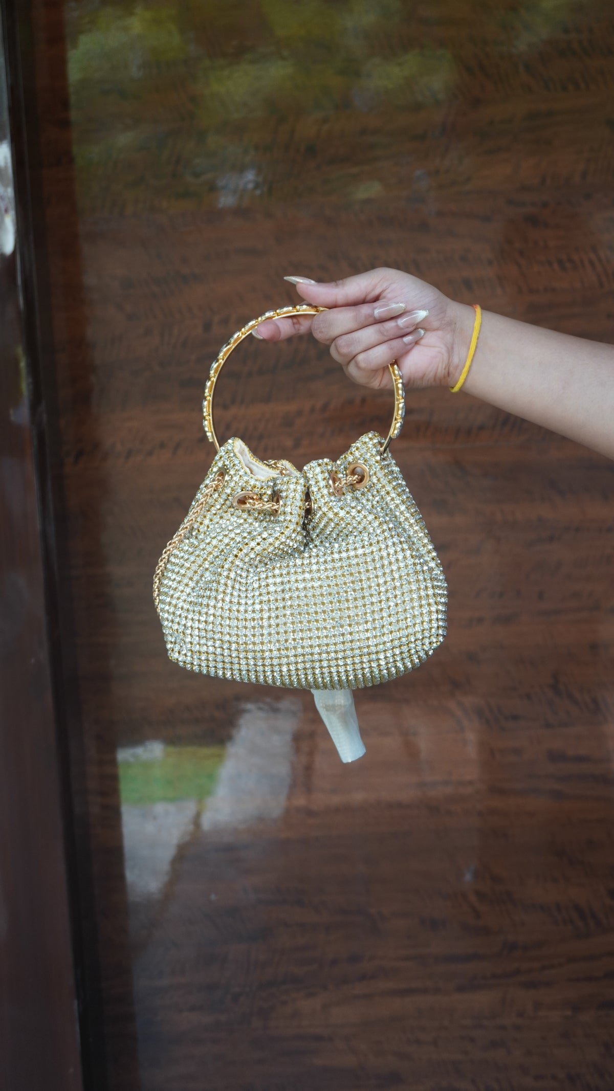 Alternate view of golden potli with small beadwork all over