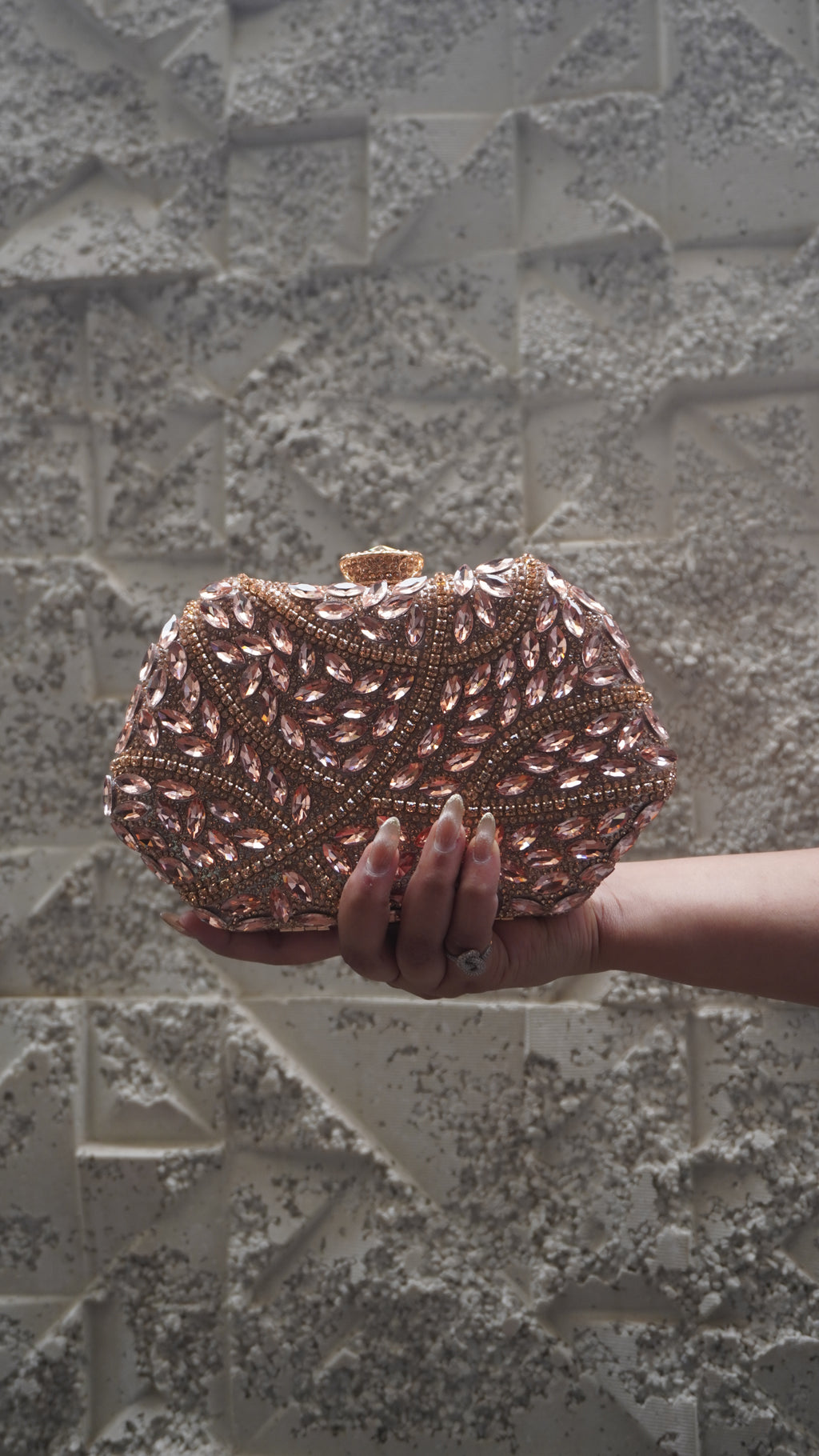 Front view of pink all-over embellished party clutch