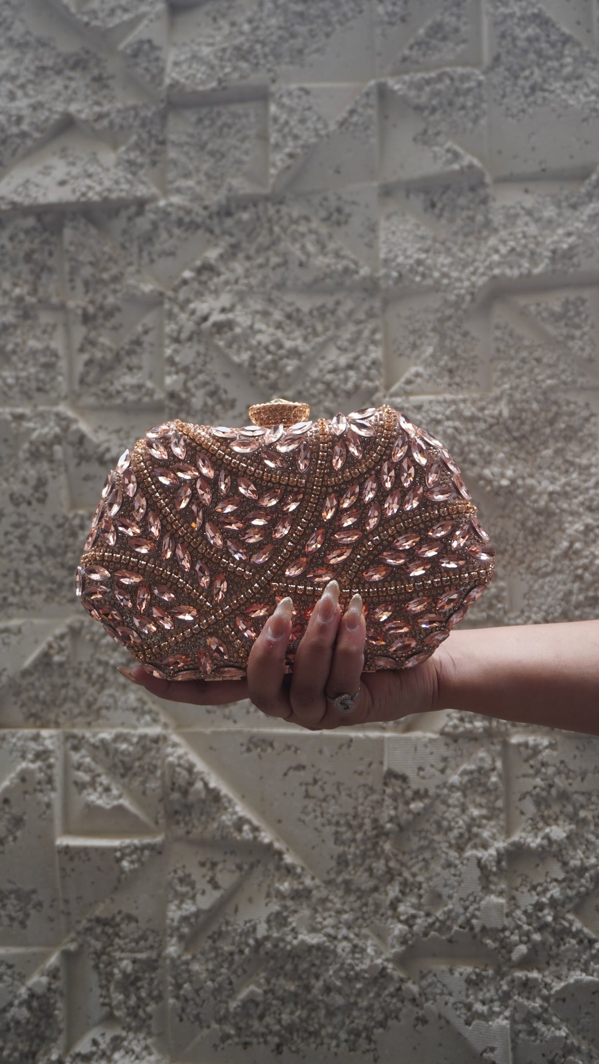 Front view of pink all-over embellished party clutch