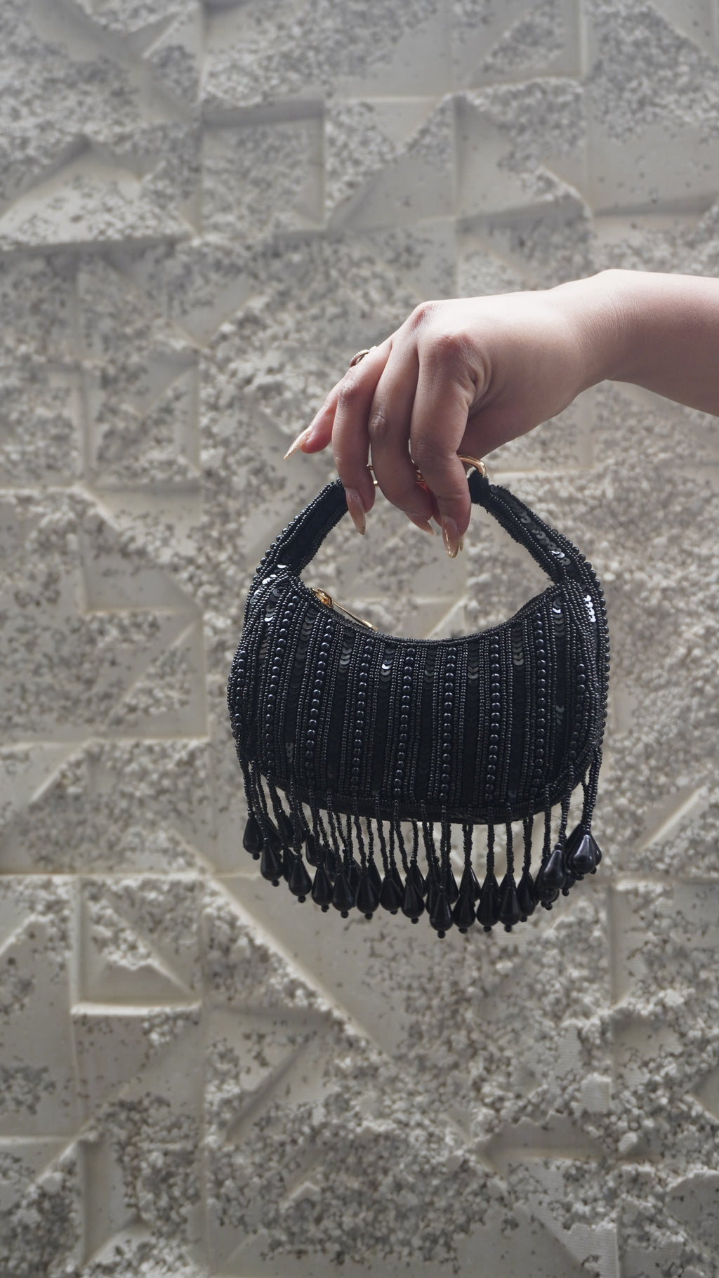 Black beaded crescent small bag with teardrop fringe and embellished handle