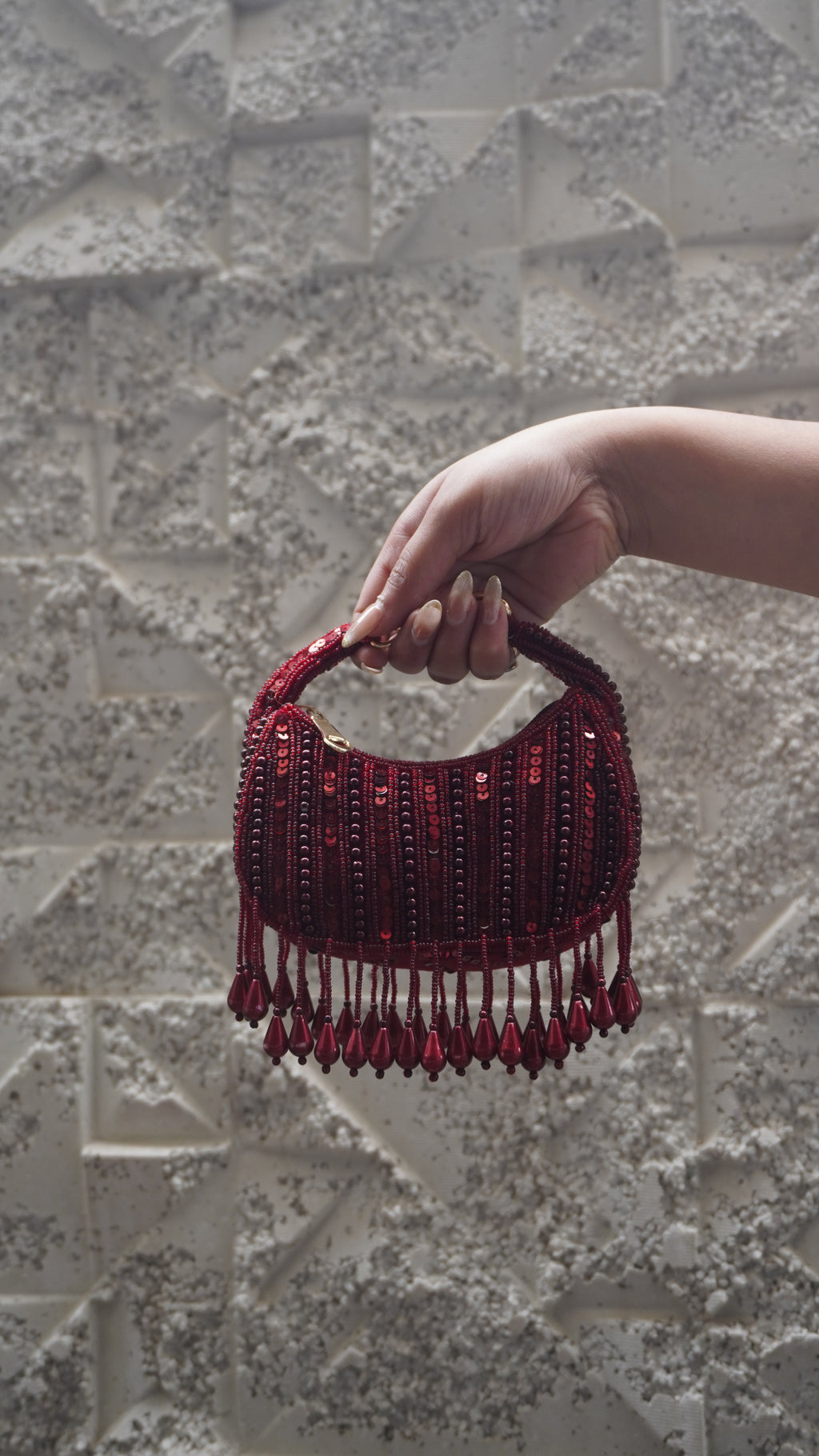 Deep red beaded small bag with teardrop fringe and short embellished handle
