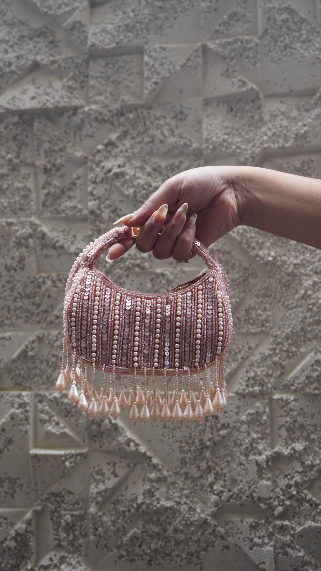 Pink beaded crescent small bag with pale teardrop fringe and embellished handle