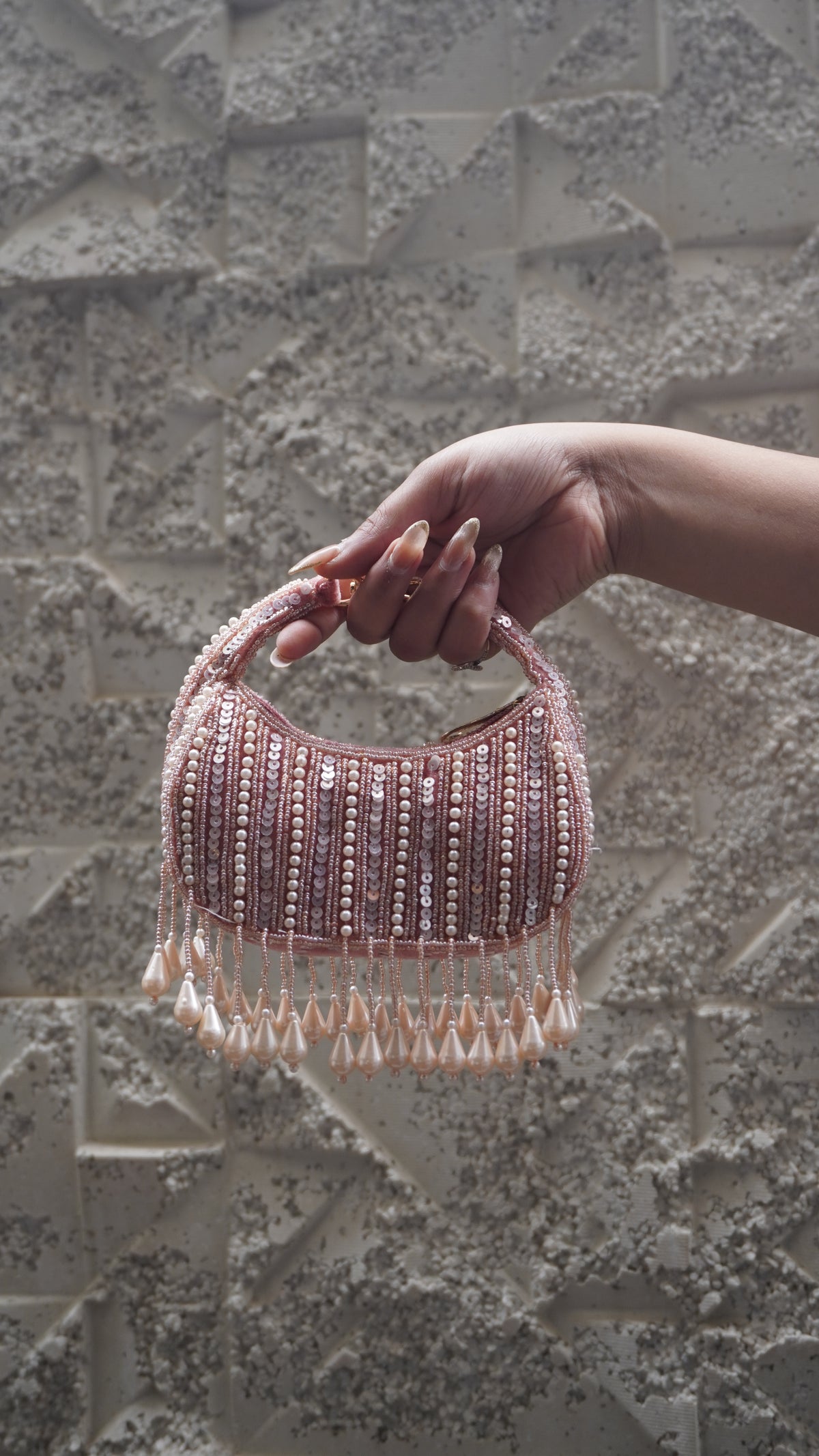 Pink beaded crescent small bag with pale teardrop fringe and embellished handle