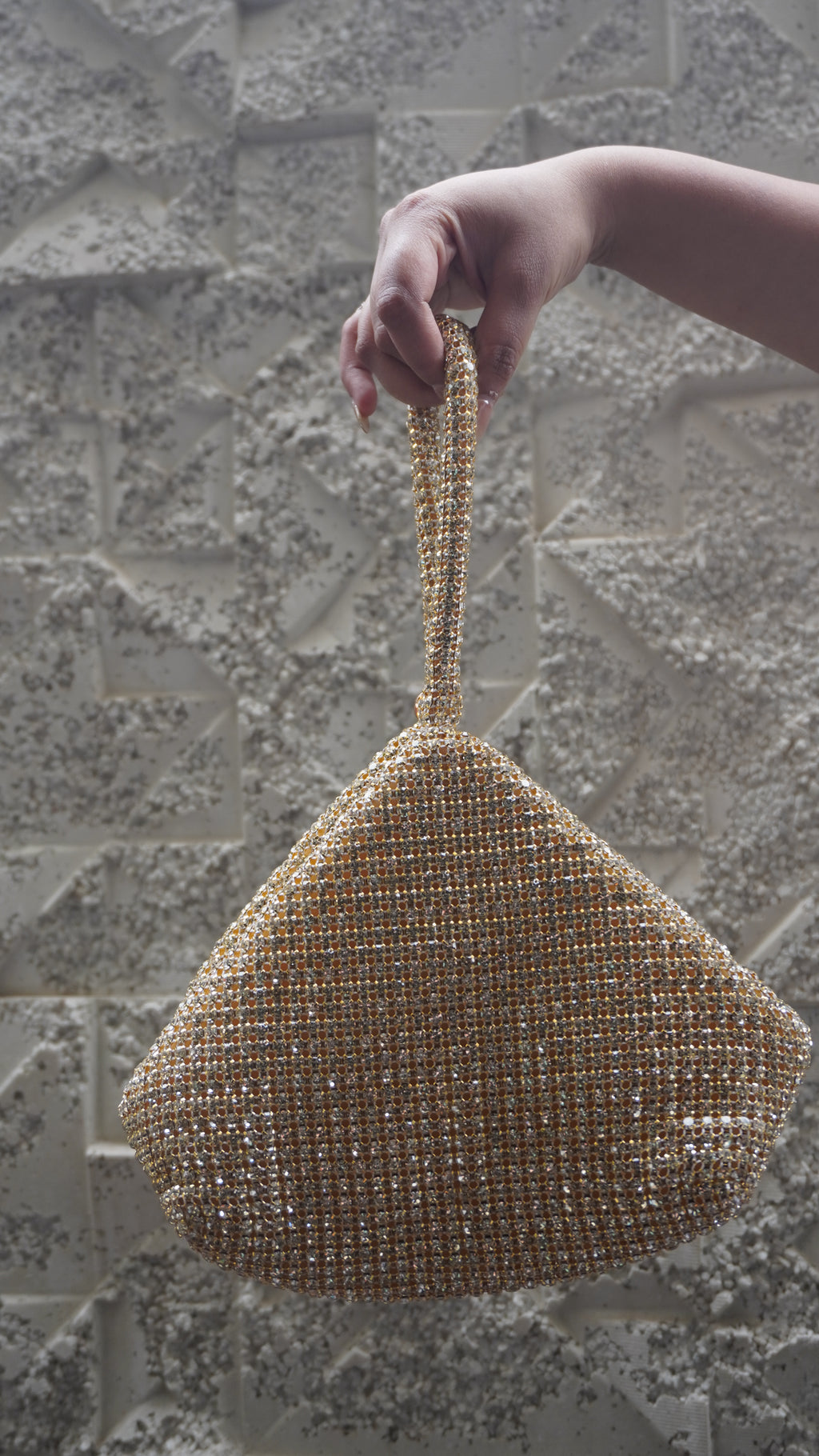 Golden triangle-shaped potli bag with all-over beadwork and embellished loop handle