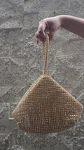 Golden triangle-shaped potli bag with all-over beadwork and embellished loop handle