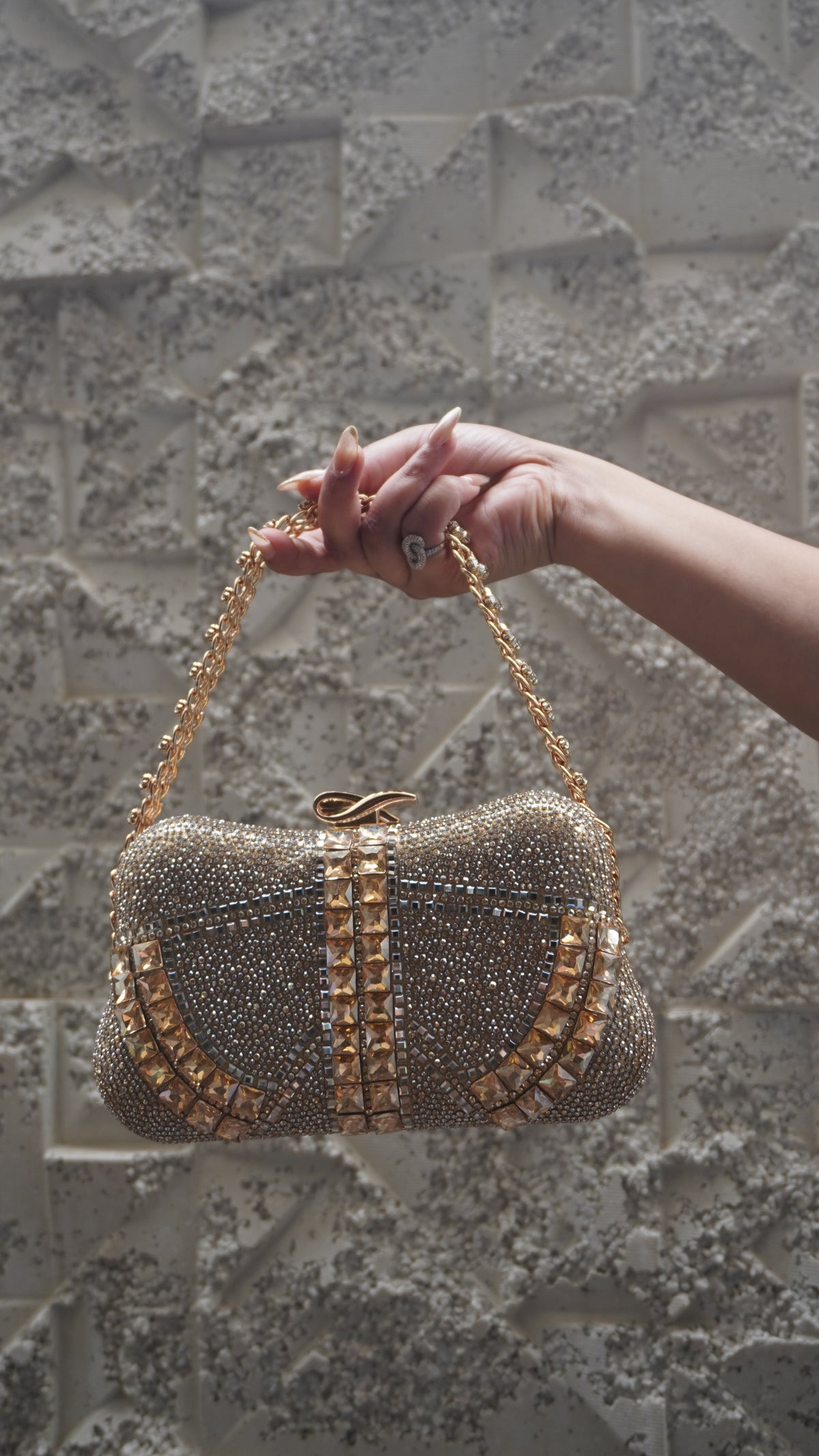 Golden party clutch showing curved faceted embellishments and fine beadwork